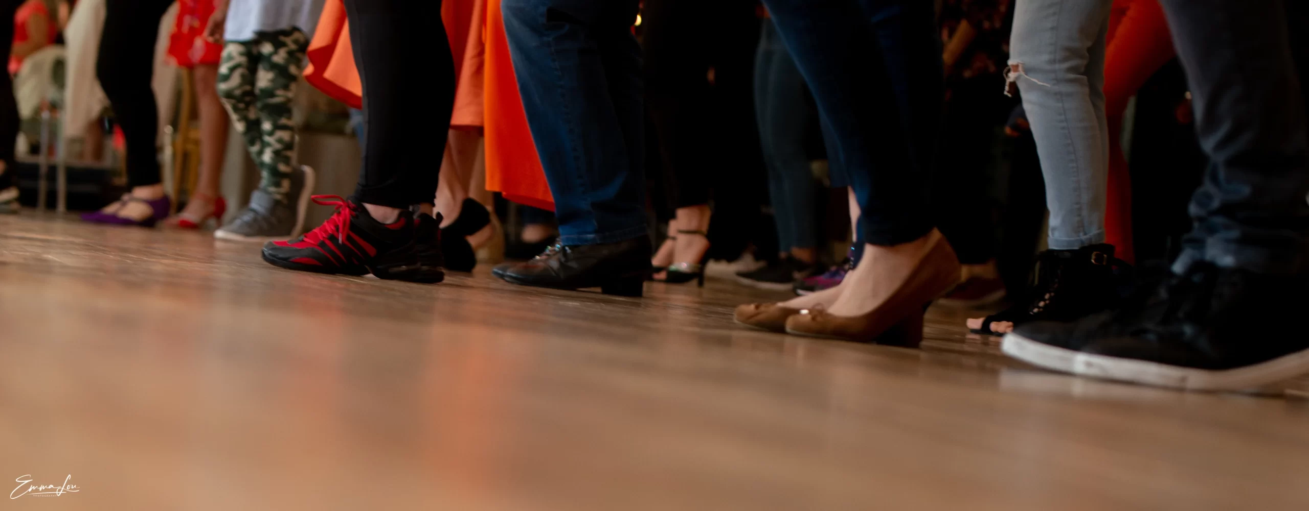 Salsa class with dancers wearing different types of shoes